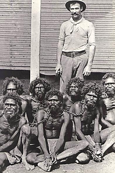 White man posing with aboriginal captives